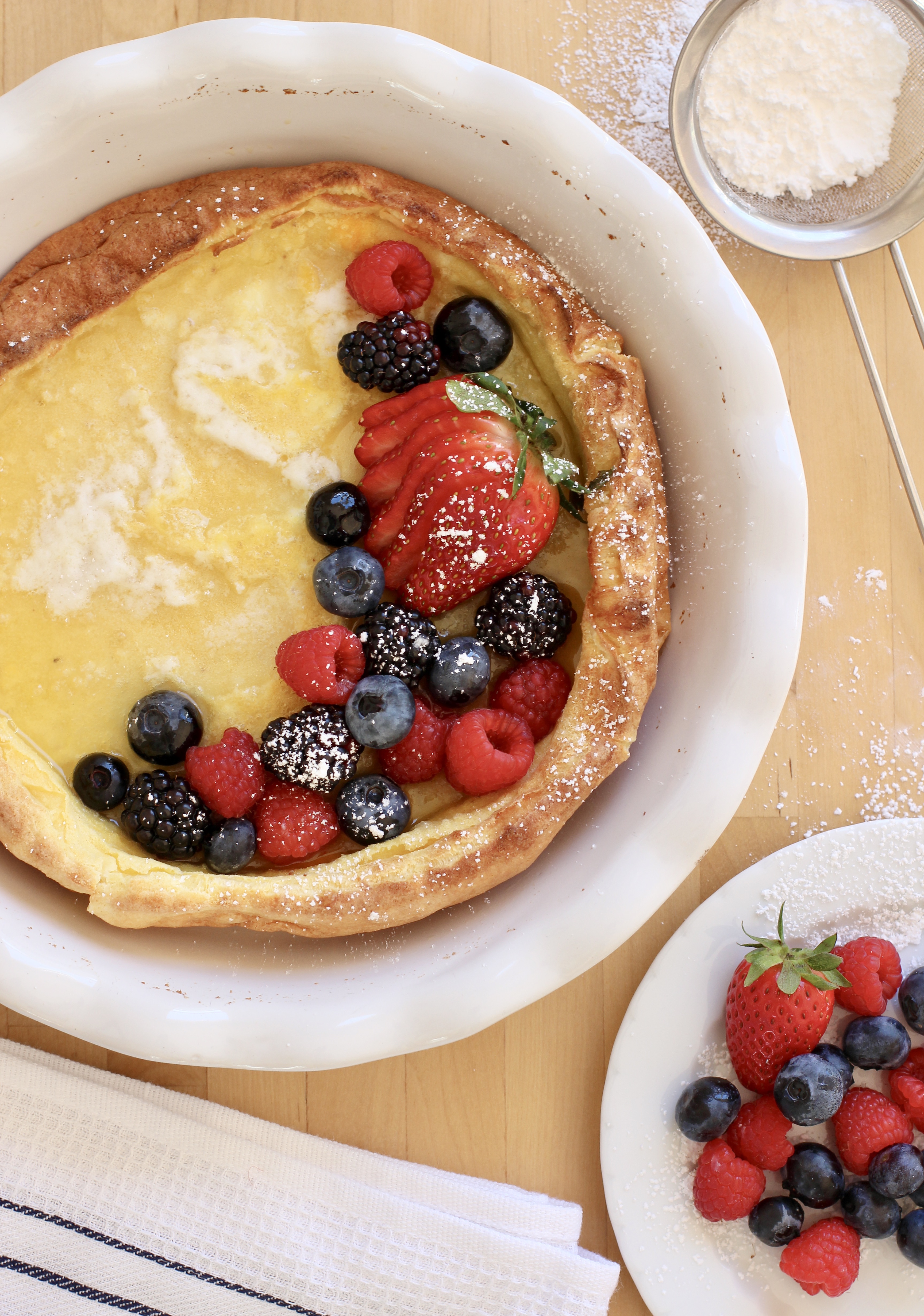 Dutch Baby with Assorted Berries breakfast in a pie dish