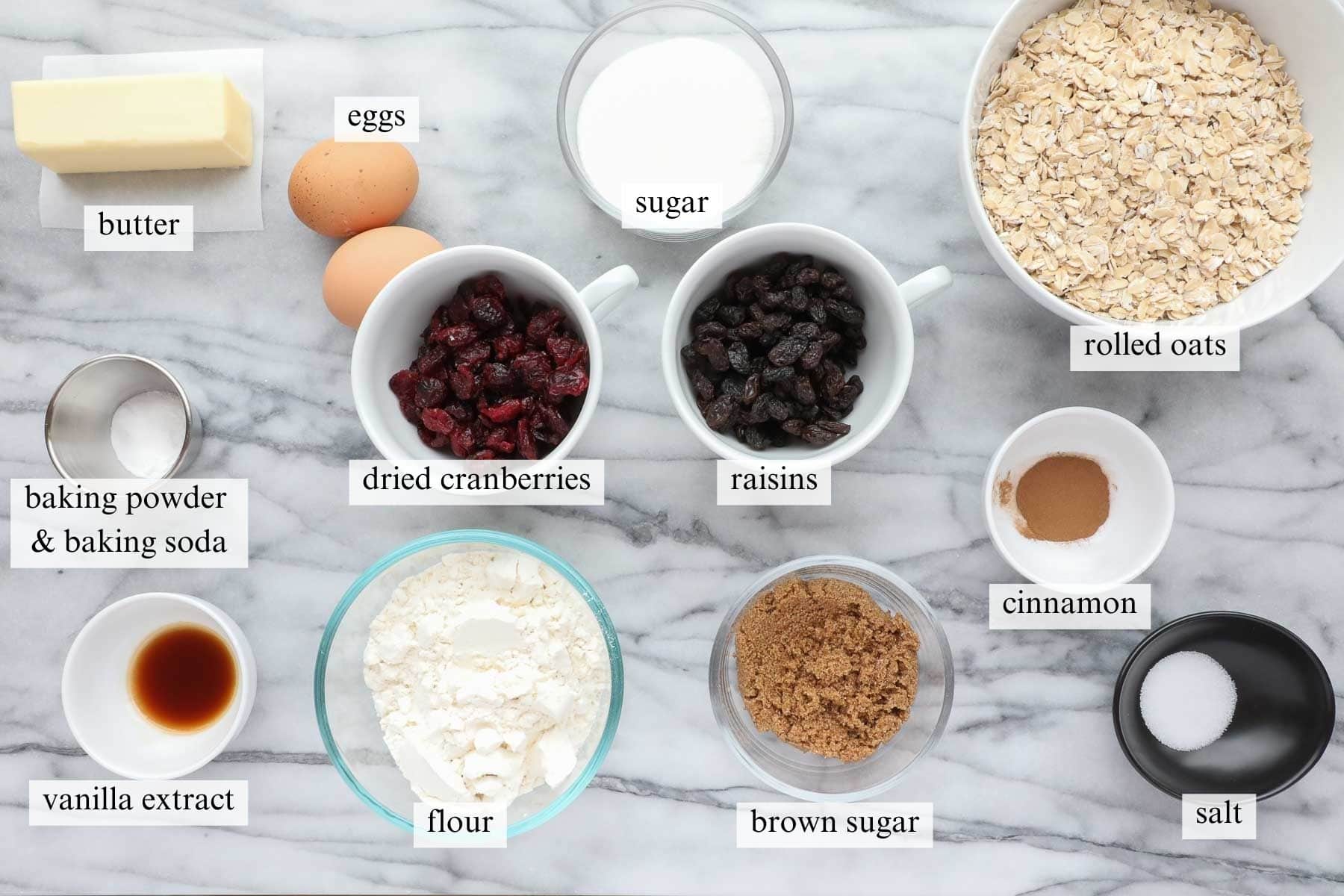 Ingredients on a counter needed to make oatmeal raisin cranberry cookies.