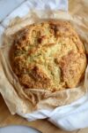 A loaf of Irish Soda Bread on a cutting board.