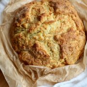 A loaf of Irish Soda Bread on a cutting board.