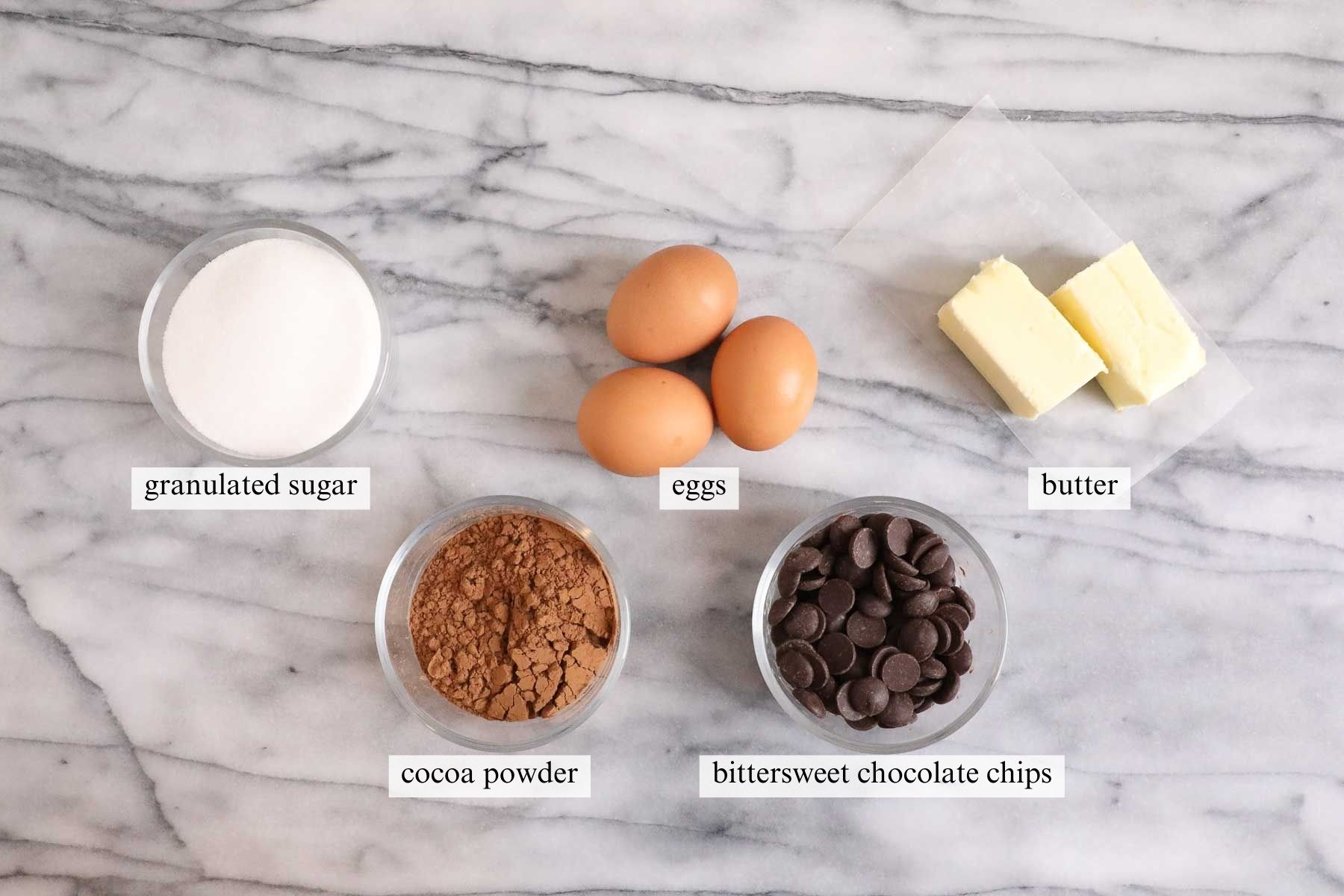 Ingredients needed to make a simple flourless chocolate cake.