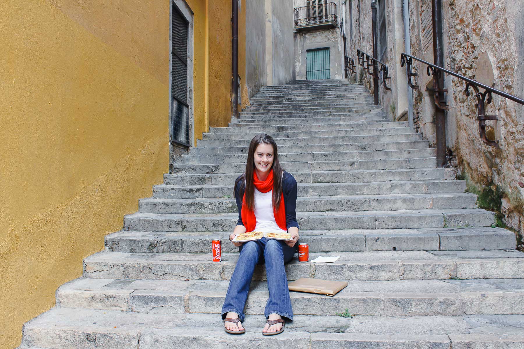 Eating roman style pizza with potatoes and rosemary on the steps of Girona in the north eastern part of Spain.
