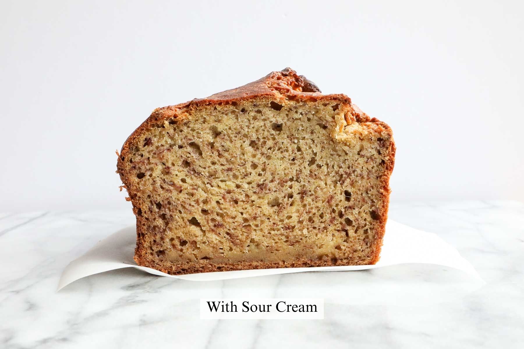 A cross section of a loaf of banana bread made with sour cream.