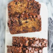 Slices of Brown Butter Chocolate Chip Banana Bread on a light background.