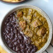 A bowl filled with half Refried Black Beans and Green Chili.