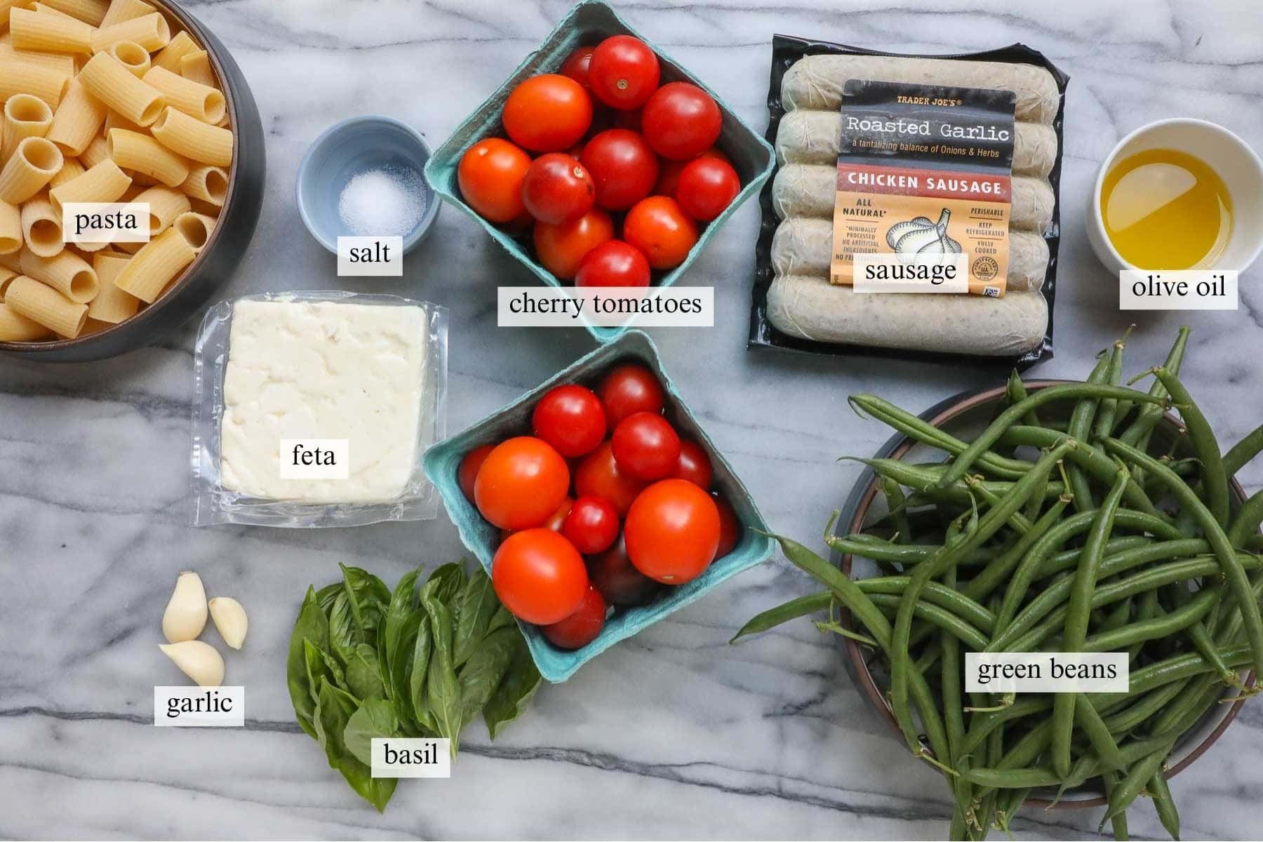 The ingredients needed to make Baked Cherry Tomatoes, Feta, and Sausage with Pasta.