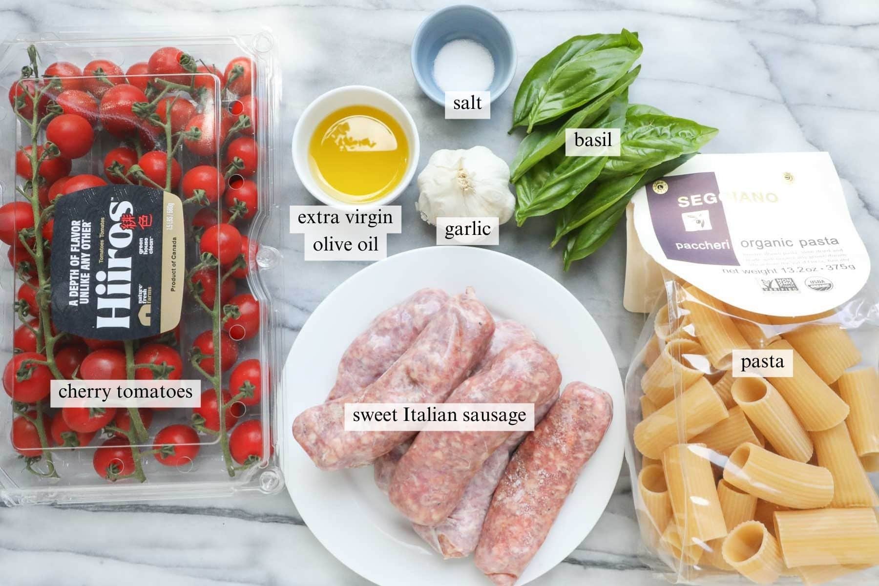The ingredients needed to make Pasta with Cherry Tomato Sauce and Italian sausage.