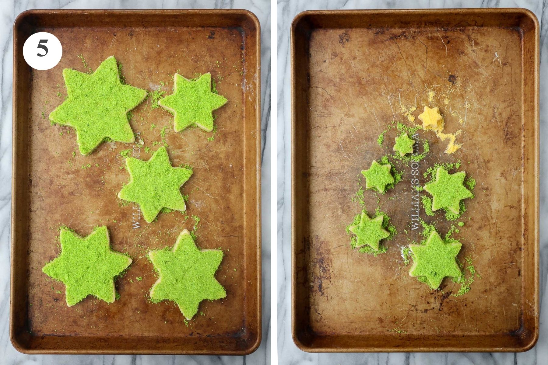 The large cookie stars on one baking sheet and the small cookie stars on a second baking sheet decorated with green sanding sugar and one small star with yellow sugar.