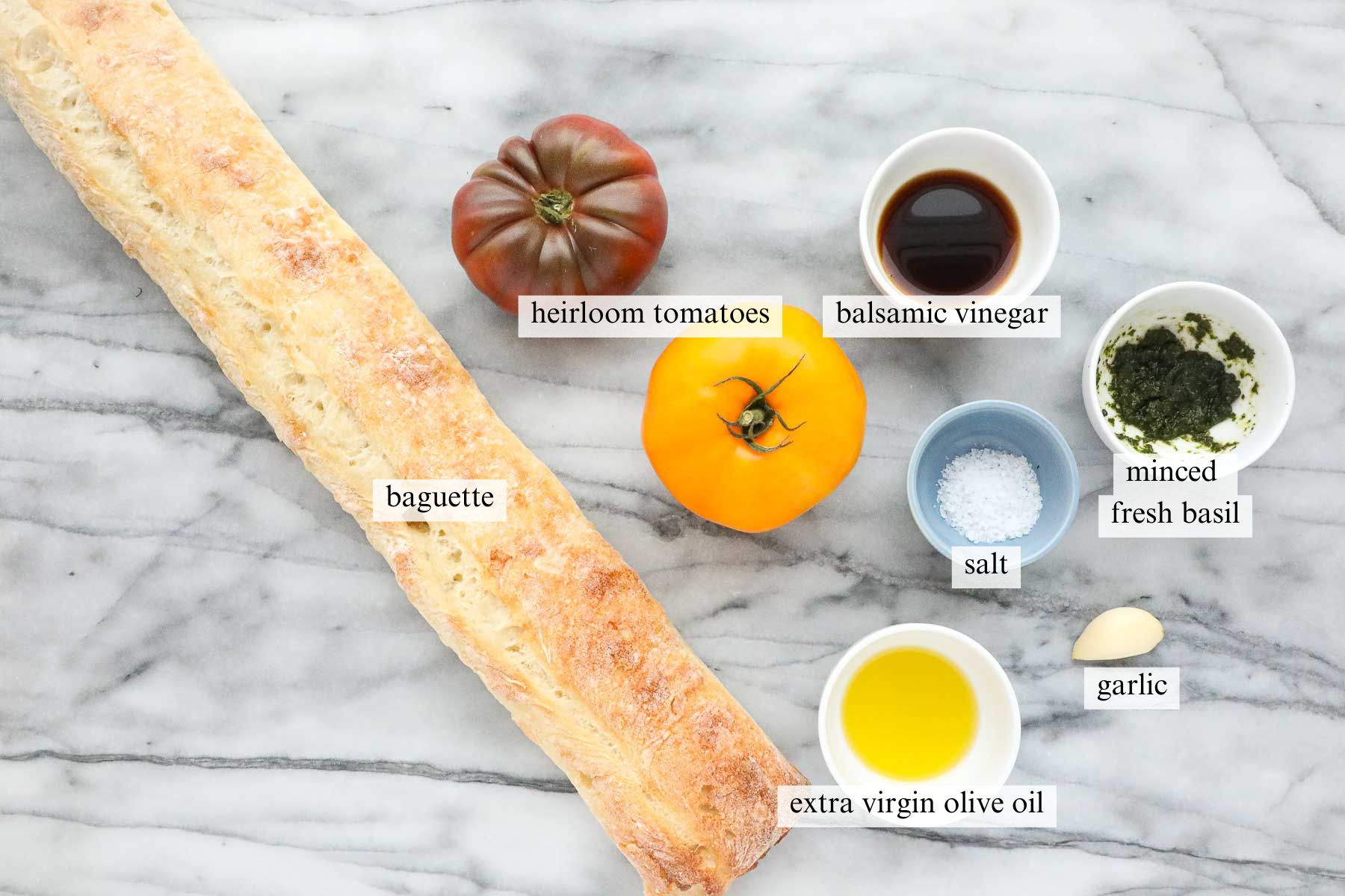 The ingredients needed to make Heirloom Tomato Bruschetta.