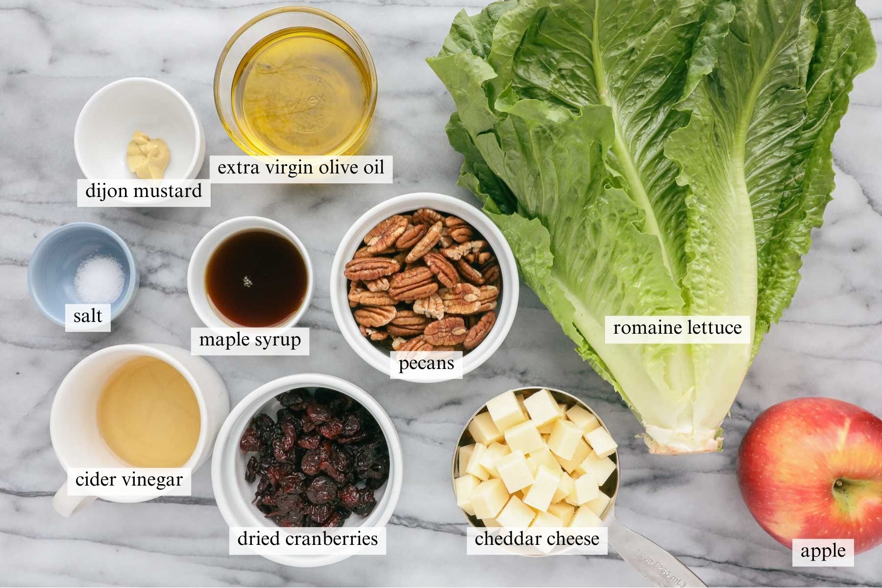The ingredients needed to make this New England Salad on a white marble background.