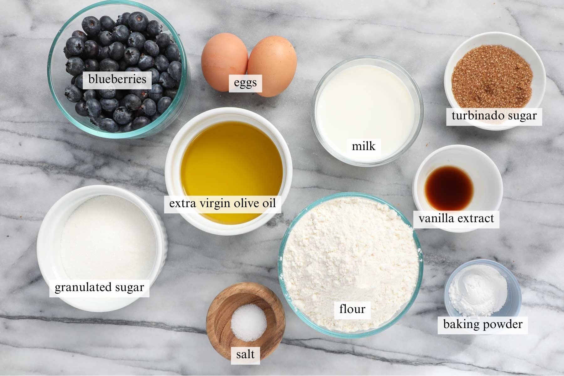 The ingredients needed to make Olive Oil Blueberry Muffins.