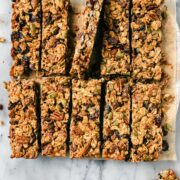 Eleven Peanut Butter Chocolate Granola Bars on a serving board cut into clean rectangles.