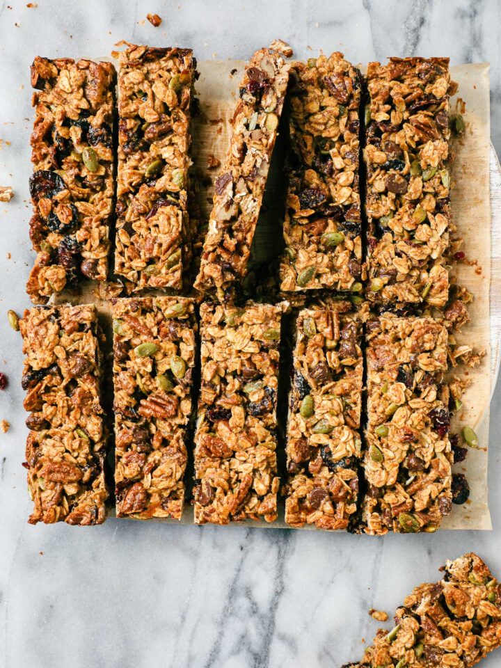 Eleven Peanut Butter Chocolate Granola Bars on a serving board cut into clean rectangles.