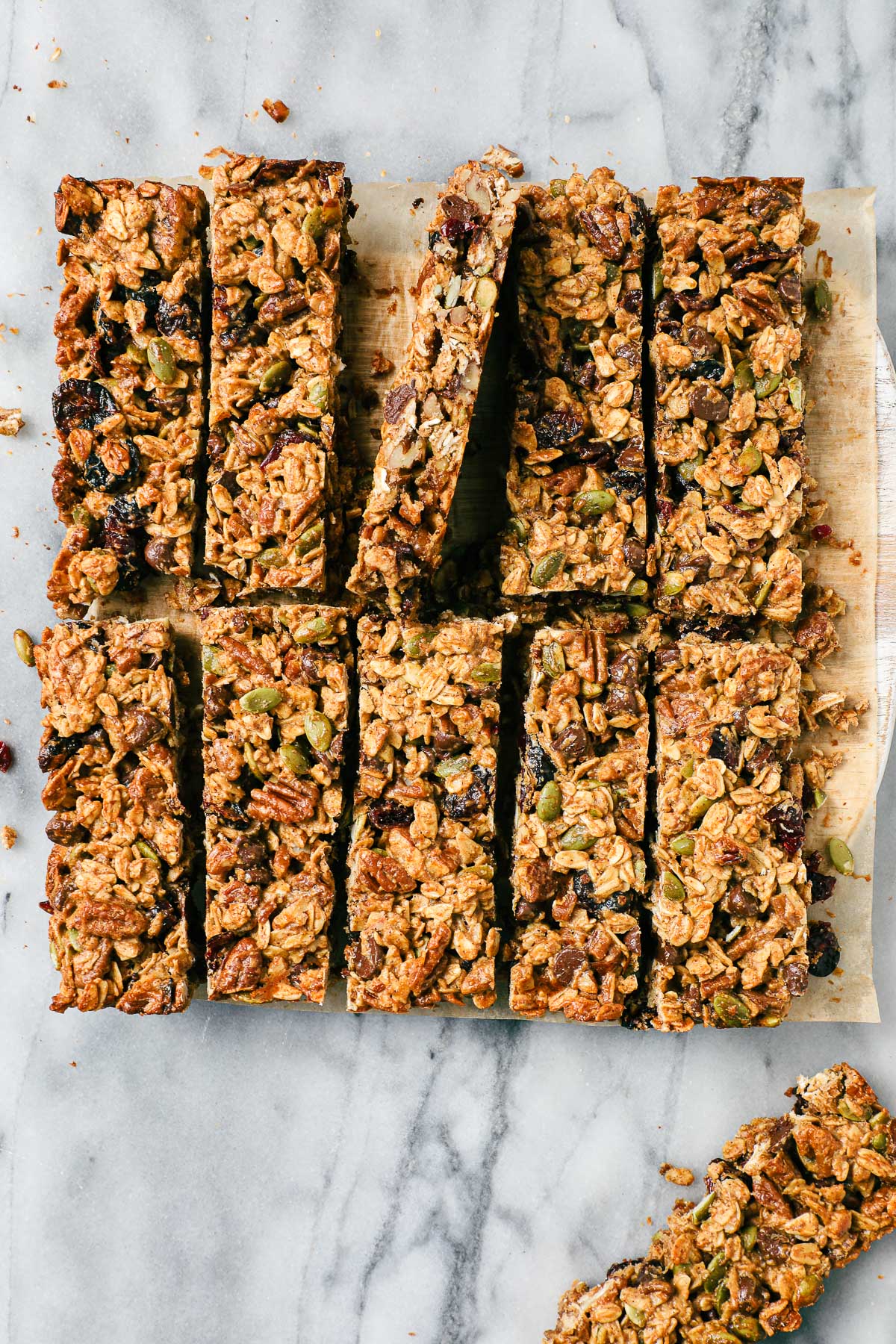 Eleven Peanut Butter Chocolate Granola Bars on a serving board cut into clean rectangles.
