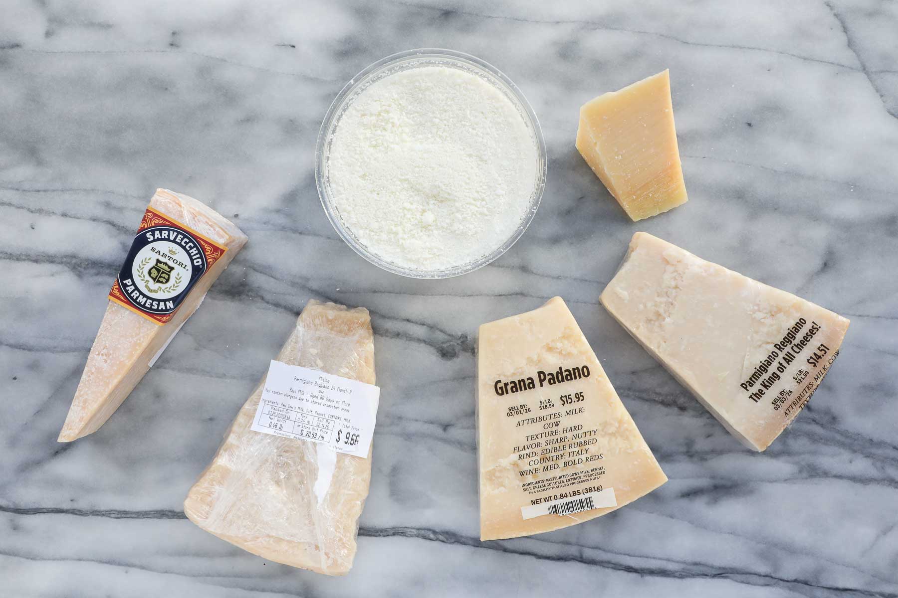 A selection of different cheeses including Pecorino Romano, parmesan, and Grana Padano.