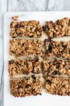 Sourdough Granola Bars from a 9x9 square metal baking dish cut into 8 large bars with chocolate chips and dried cranberries.