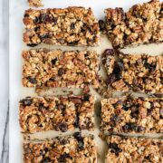 Sourdough Granola Bars from a 9x9 square metal baking dish cut into 8 large bars with chocolate chips and dried cranberries.
