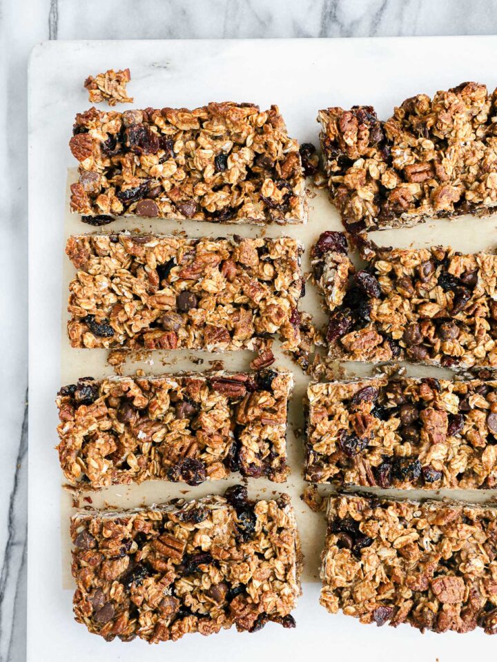 Sourdough Granola Bars from a 9x9 square metal baking dish cut into 8 large bars with chocolate chips and dried cranberries.