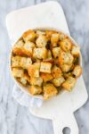 Crispy golden focaccia croutons with Italian seasoning in a serving dish.