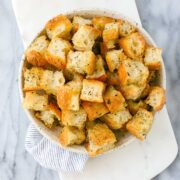 Crispy golden focaccia croutons with Italian seasoning in a serving dish.