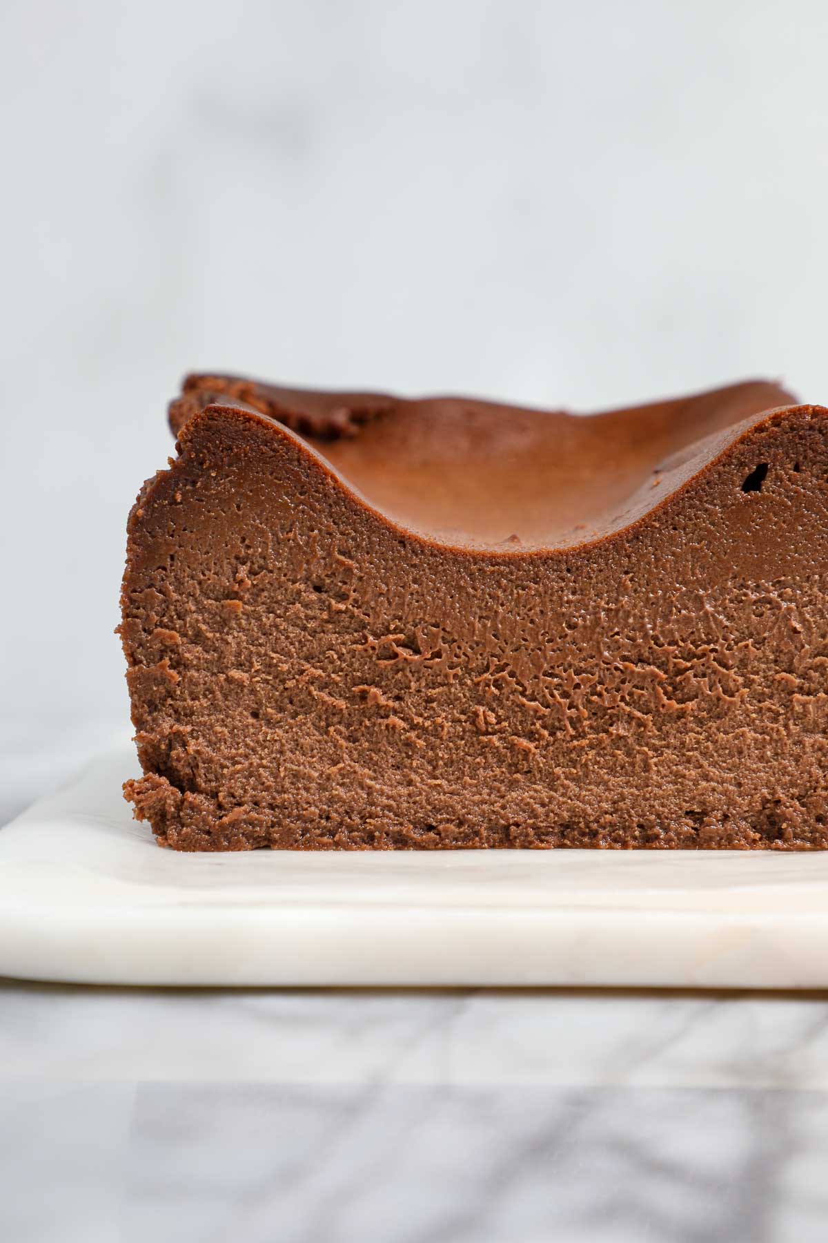 The cross section of a Chocolate Loaf Basque Cheesecake showing the creamy chocolatey interior.