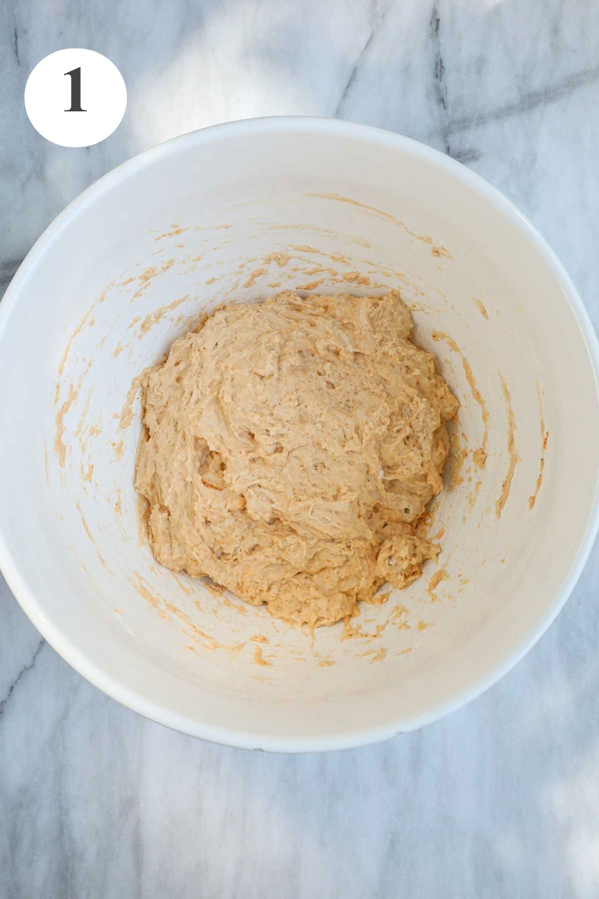 The Sweet Pumpkin Focaccia dough ingredients roughly combined in a white mixing bowl.