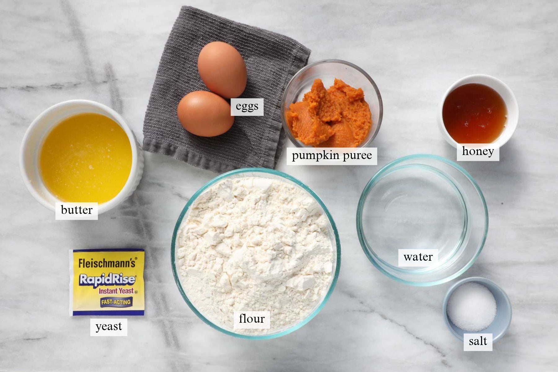 The ingredients needed to make Pumpkin Dinner Rolls.